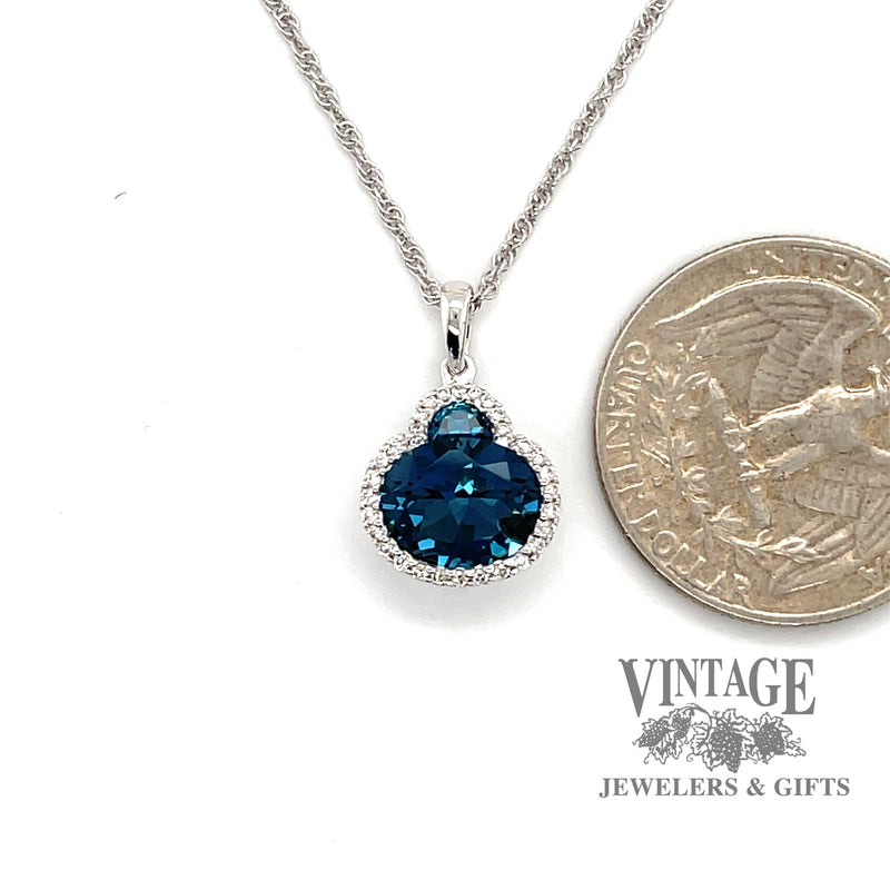 14 karat white gold 2.86 carat total weight Blue Topaz and diamond halo necklace, shown with quarter for size reference