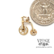 Old timey bicycle charm in 10ky quarter for scale