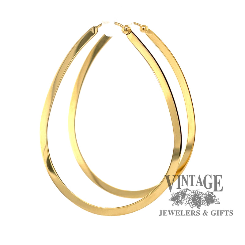 Large 14K gold flat teardrop shaped hoops from side