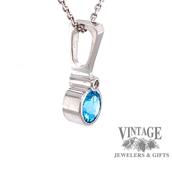 14 karat white gold blue topaz pendant with diamond accent, side view