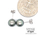 8.5 mm 14 karat white gold Tahitian pearl stud earrings with quarter for scale
