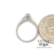 .31 carat octagonal platinum solitaire ring next to quarter for scale