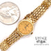 Ladies Baume & Mercier 14 karat yellow gold bracelet watch, shown with quarter for size comparison