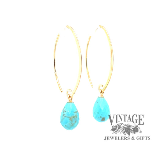 14 karat yellow gold sweep earrings with faceted turquoise drops, angled view