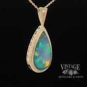 14 karat yellow gold 9.63ct Pear shape opal with diamonds pendant, angled view
