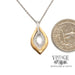 14 karat two tone diamond leaf shape necklace, shown with quarter for size reference