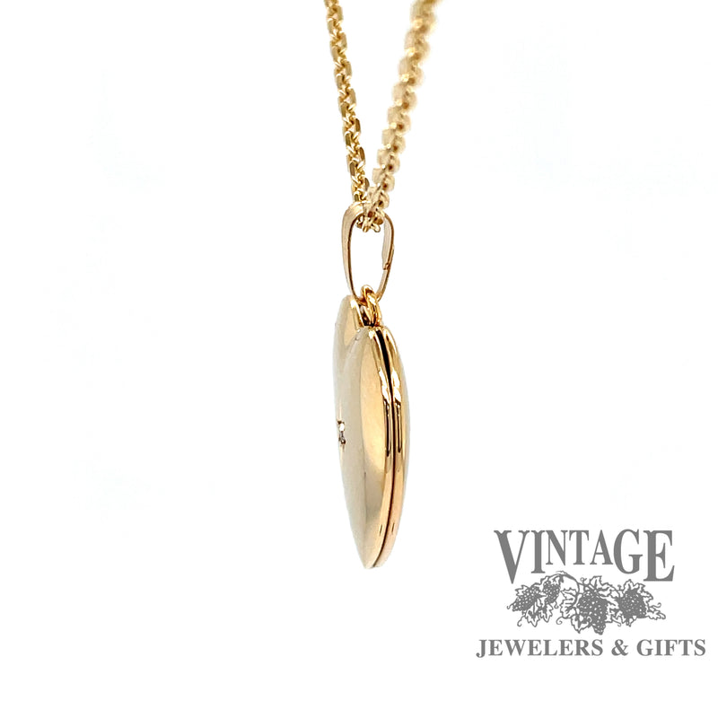 side view of 14 karat yellow gold diamond center heart locket