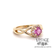 Custom 14 karat yellow gold pink sapphire with diamond halo ring, oblique view