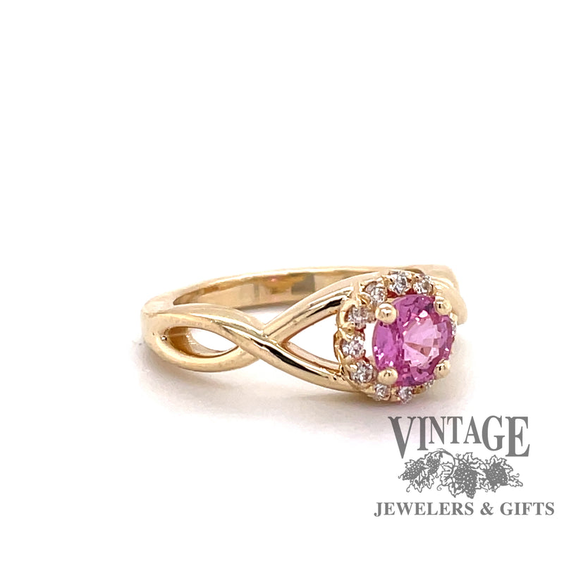 Custom 14 karat yellow gold pink sapphire with diamond halo ring, oblique view