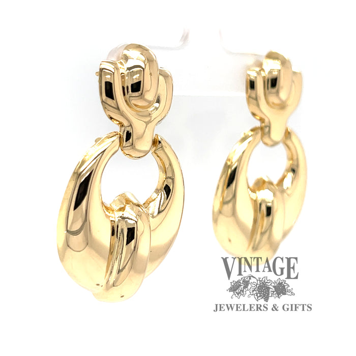18 karat yellow gold doorknocker style drop earrings, angled view