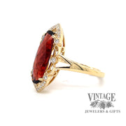 14 karat yellow gold 2.58 carat oval garnet and diamond ring, angled view