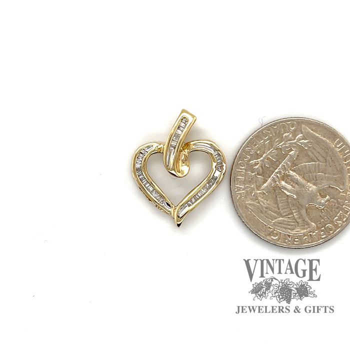 10 karat yellow gold .30ctw diamond heart shape pendant, shown with quarter for size reference