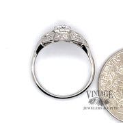 .64 carats total weight vintage platinum Art Deco diamond ring, side view through finger, shown with quarter for size reference