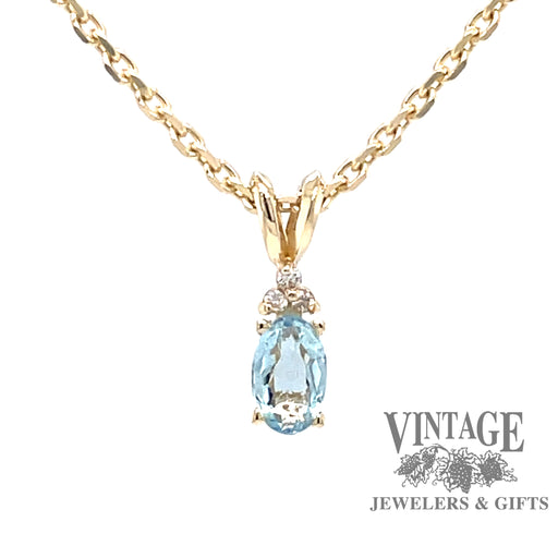 14 karat yellow gold pendant with natural oval shaped aquamarine and diamond accents