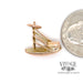 14 karat yellow gold estate Chinese junk boat charm, shown along side quarter for size reference