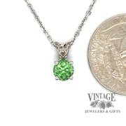 14 karat white gold 1.04 carat round tsavorite pendant, shown with quarter for size reference