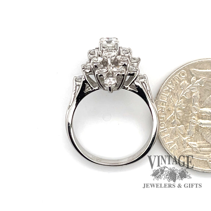 14 karat white gold 1.17ctw diamond cluster ring, side through finger , shown with quarter for size reference