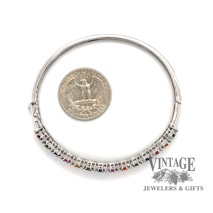 14 karat white gold multi colored sapphire bangle bracelet, looking through bracelet, shown with quarter for size reference