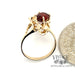 14 karat yellow gold 1.70ct oval garnet freeform ring, shown with quarter for size reference