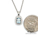 14 karat white gold 1.02ct aquamarine diamond halo pendant, shown with quarter for size reference
