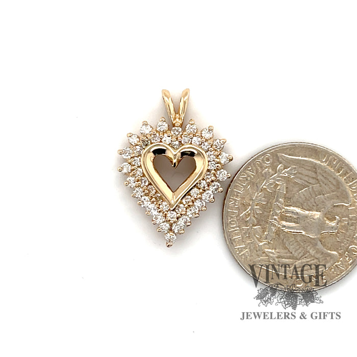 14 karat yellow gold heart shaped two row diamond pendant, shown with quarter for size reference