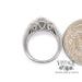 14 karat white gold three stone diamond ring, shown with quarter for size reference