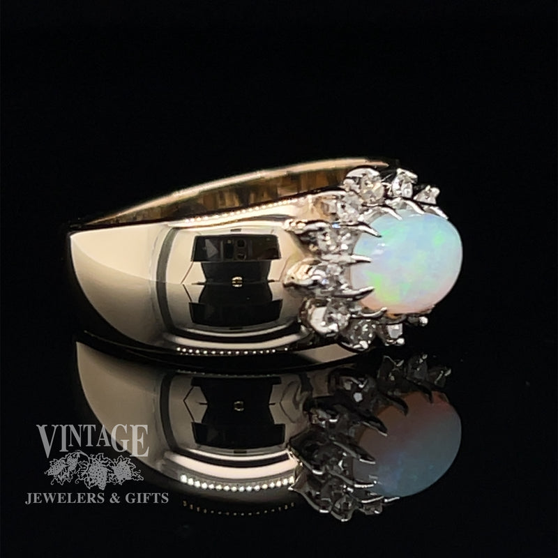 14 karat yellow gold opal and diamond sideways halo ring, angled view. Note: There are no hearts or black areas on the band of the ring. It is camera reflection