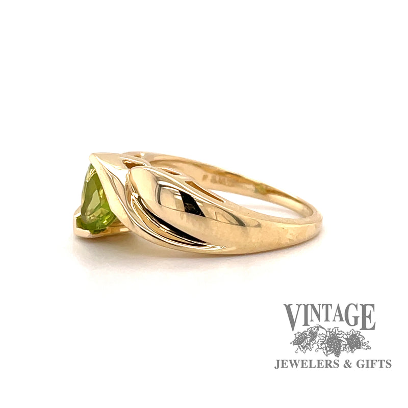 14 karat yellow gold trillion shaped peridot bypass style ring, side view