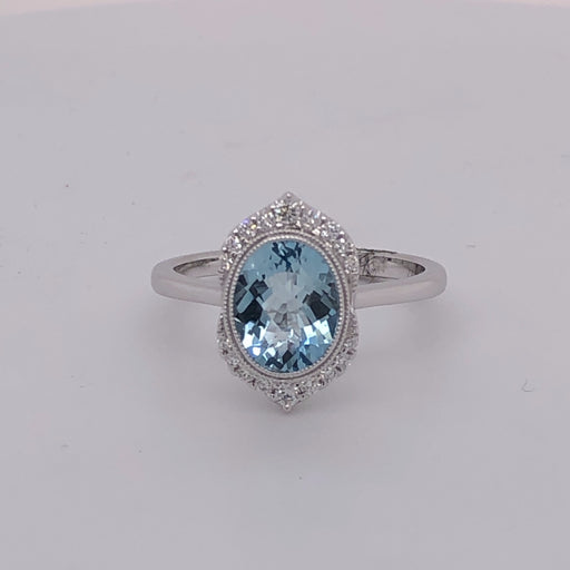 14 karat white gold aquamarine ring with diamonds top and bottom.