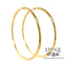 Endless extra large 14k gold hoops, side angled view