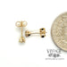 14 karat yellow gold .20 carat total weight diamond stud earrings, shown with quarter for size reference