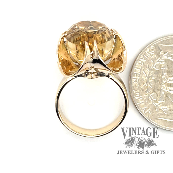 14 karat yellow gold oval golden citrine belcher style ring, next to quarter for scale