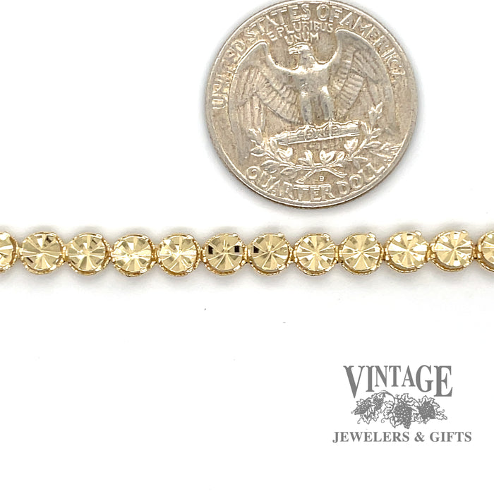 14 karat yellow gold 7" round Illusion link bracelet, shown with quarter for size reference