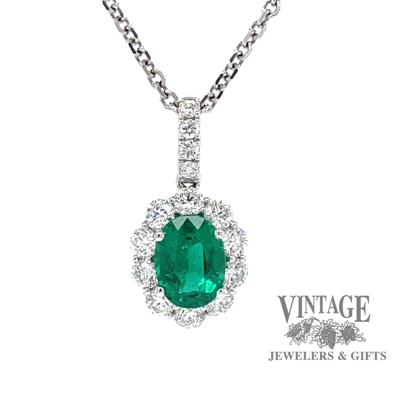 Emerald and diamond 18k white gold halo pendant.