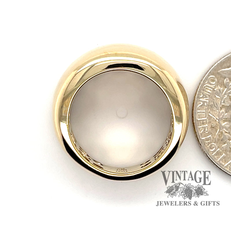 14 karat yellow gold wide domed and tapered band, side view through finger, next to quarter for size reference