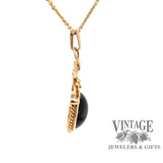 side view of 14 karat yellow gold dark green cat's eye tourmaline pendant