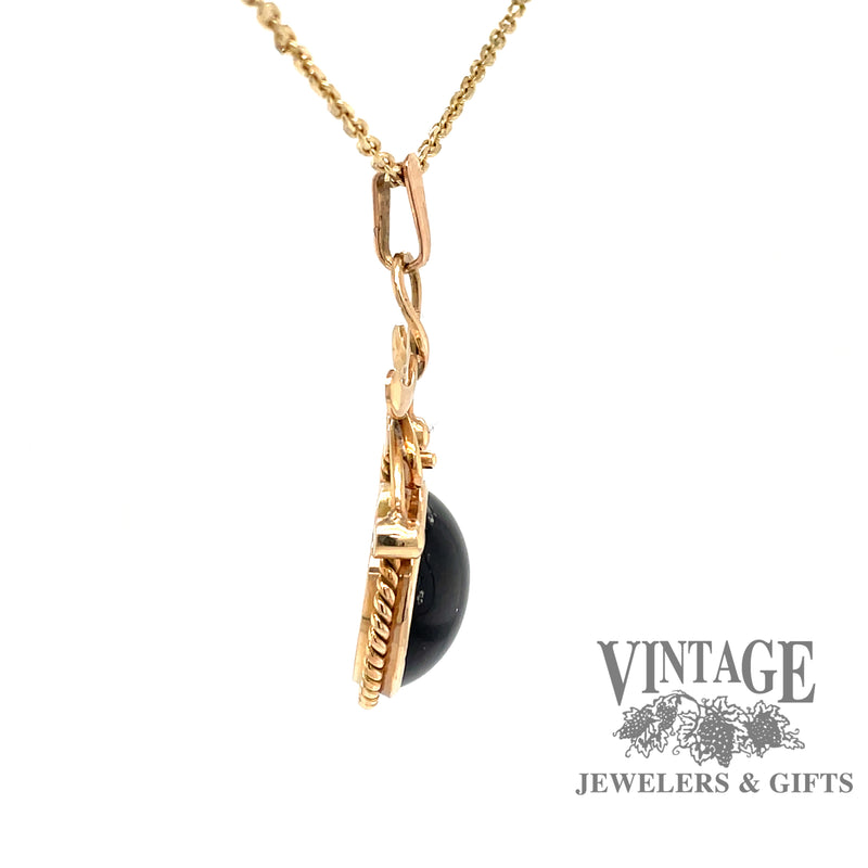 side view of 14 karat yellow gold dark green cat's eye tourmaline pendant