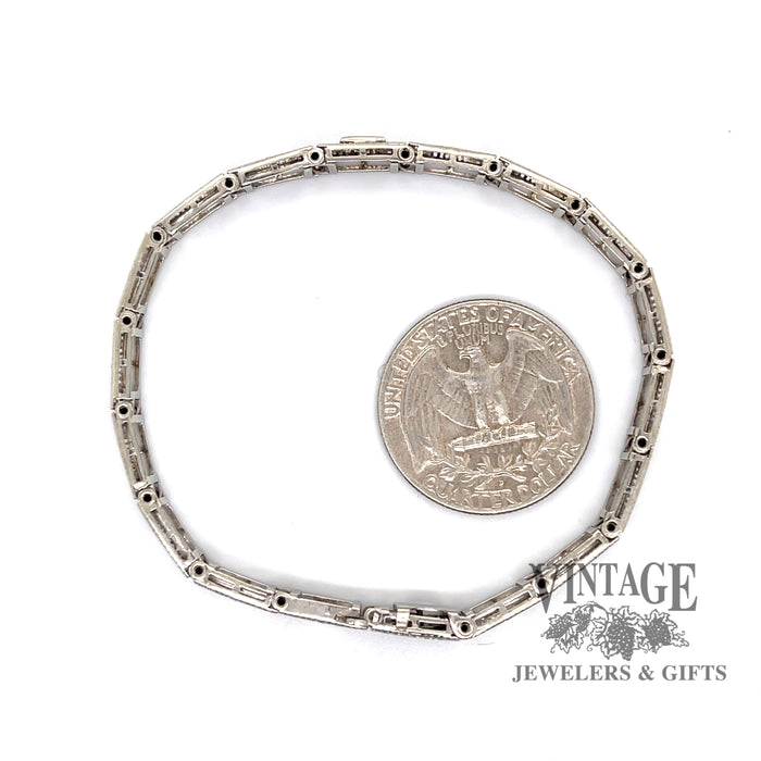 Antique 14 karat white gold filigree diamond bracelet shown with quarter for size reference