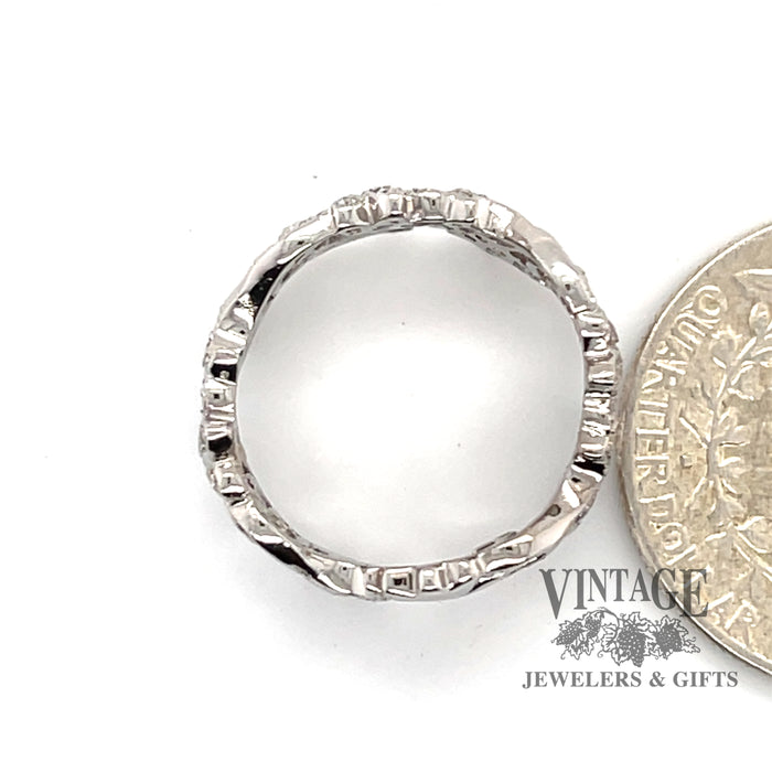18 karat white gold .24ctw diamond floral motif band ring, side through finger, next to quarter for size reference