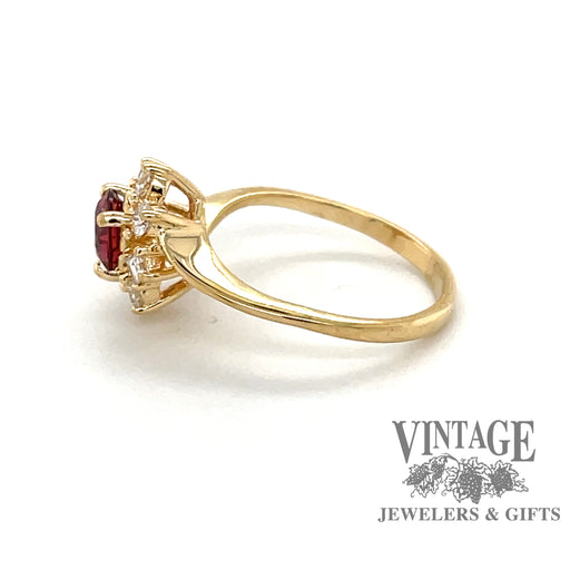 Round pink sapphire ring in 14 karat yellow gold with halo diamonds side