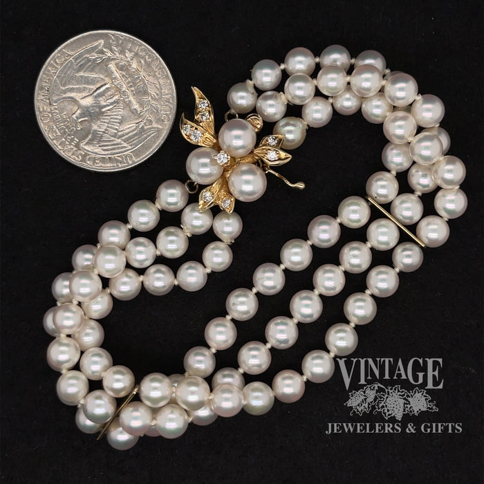14 karat yellow gold 3 strand pearl fancy clasp bracelet, shown with quarter for size reference