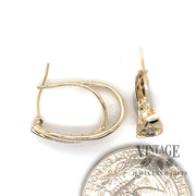 14 karat yellow gold estate diamond hoops with a crossed double oval loop design, alternate side view shown with quarter for size reference
