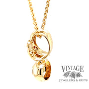 side view of 14 karat yellow gold diamond slide pendant.