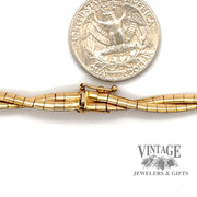14 karat yellow gold 16.5" Braided omega chain necklace, close up of clasp & next to quarter for size reference