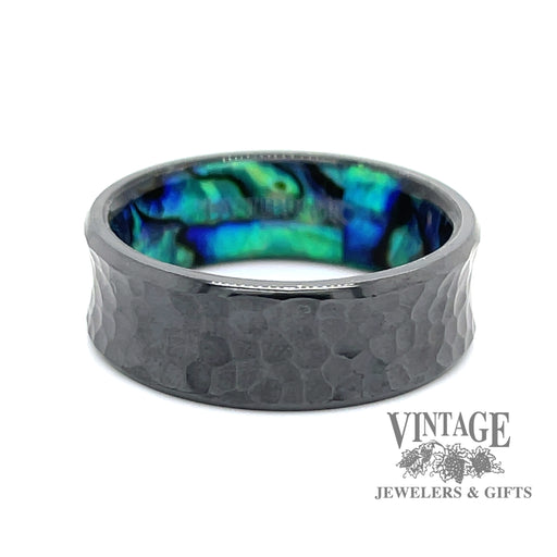 Hammered black zirconium band ring surrounds an inner sleeve of blue green abalone.