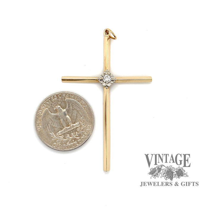 14 karat yellow gold diamond solitaire large cross, shown with quarter for size reference