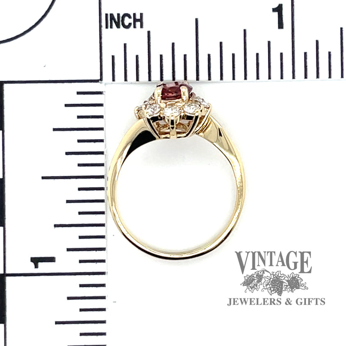 Round pink sapphire ring in 14 karat yellow gold with halo diamonds scale