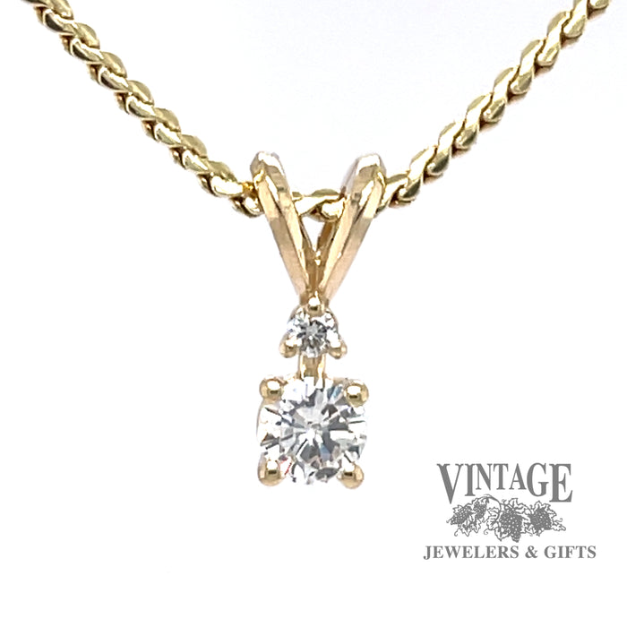14 karat yellow gold .23 carat diamond pendant with small accent diamond
