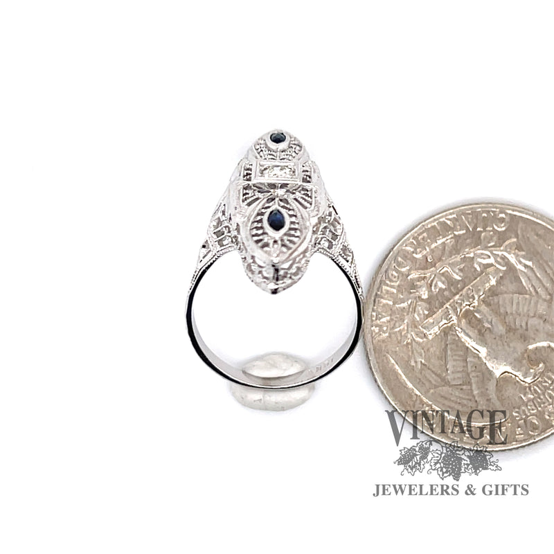 18 karat white gold vintage filigree elongated sapphire and diamond ring, shown with quarter for size reference