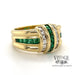 18 karat yellow gold emerald and diamond channel set band ring, angled view